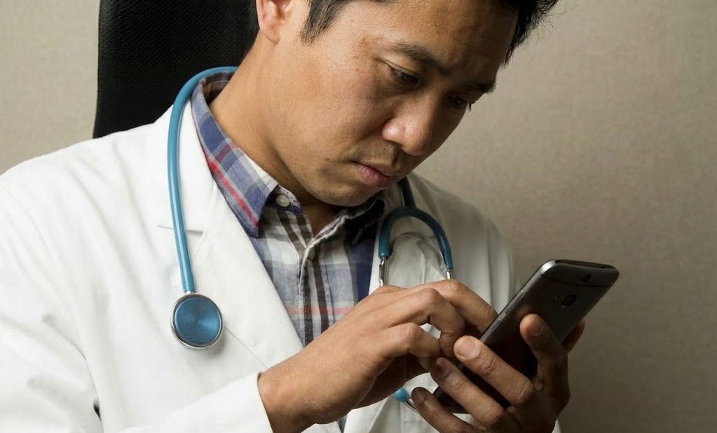 Vietnamese doctor using phone